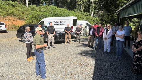Photos by Randy Foster/editor@cherokeescout.com Top: Valley River Humane Society Board of Directors President Don Reynolds (bottom left) addresses a crowd at the unveiling of a new building addition at the animal shelter in Marble on Aug. 27. 