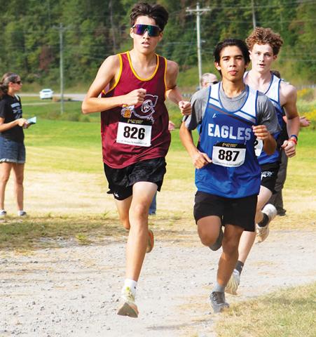 Cannon Crompton/sports@cherokeescout.com Oscar Page (right) of Hiwassee Dam and King Beheler (left) of Cherokee run close with Jonah Dockery of Hiwassee Dam just behind them in the meet on Sept. 24. 