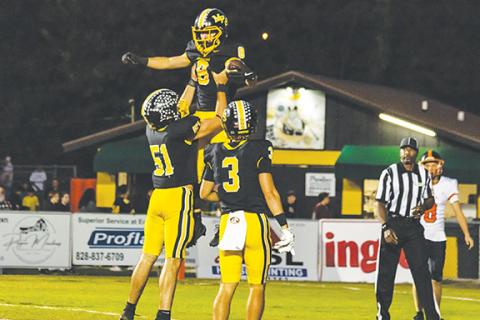 Cannon Crompton/sports@cherokeescout.com Blake Davis gets lifted up by Landen Lape after scoring a touchdown against Rosman on Friday night. 