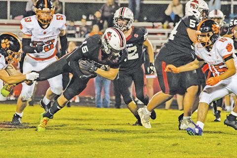 Cannon Crompton/sports@cherokeescout.com Kelby Waldroup of Andrews dives for addition yardage during a run against Rosman on Friday night.