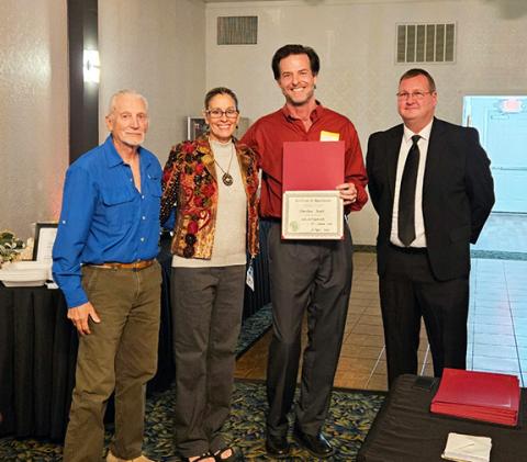 Matthew Crawford/Contributing Photographer  Cherokee Scout Publisher David Brown, Staff Correspondent Anngee Quinones-Belian and Contributing Photographer Bill Belian were recognized for promoting volunteerism on Oct. 18. At right is event emcee Tim Radford.