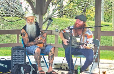 Photos by Nicole Wright/Staff Correspondent Chris Blaylock (left) joins Woolybooger, aka Gavin Heath Graves, on stage for some old time blues and Americana music during the September Food Truck Friday in downtown Andrews. The next event is scheduled for Oct. 24. 
