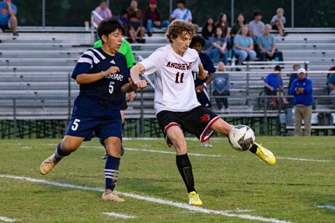 Cannon Crompton/sports@cherokeescout.com Andrews’ Ethan Barton (right) kicks the ball while Tri-County Early College’s Elias Diaz-Menchu (left) defends in their match on Oct. 9. 