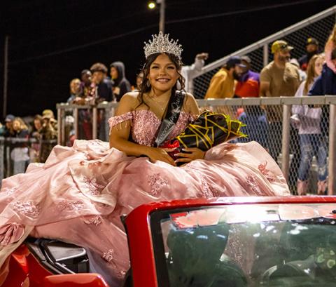 Cannon Crompton/sports@cherokeescout.com Kaiya Ellis takes a ride in the Chevrolet Camaro driven by her father, James Ellis, after being named the 2025 Andrews High School homecoming queen Friday night. See every member of the Wildcats’ court on page 12A.