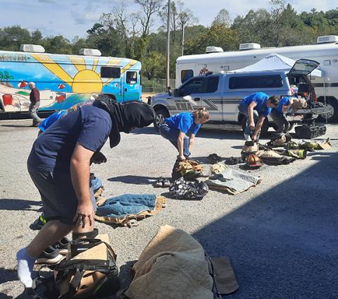 Photos by Anngee Quinones-Belian/Staff Correspondent  Firefighters race against one another to see who can don their gear the fastest Saturday. The winner was Lt. Dakota Thrower of the Ranger Volunteer Fire Department. 