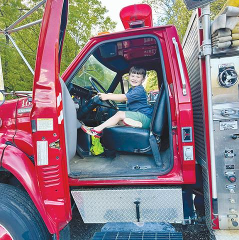 Photos by Aiden McCoy Williams/Staff Correspondent Kids were all smiles when volunteer firefighters gave them the chance to sit in the front of one of their trucks.