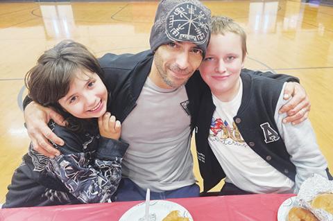 Photos by Nicole Wright/Staff Correspondent Fifth-grader Joshlynn Fontenot (left) enjoys breakfast with her dad, Josh Fontenot (center), and step-brother and fellow fifth-grader Landan Adams during Andrews Elementary School’s Veterans Breakfast on Nov. 10. Fontenot is a U.S. Navy veteran. More photos, page 8A.