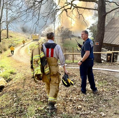 Randy Foster/editor@cherokeescout.com Firefighters respond to a blaze at 381 John Taylor Road on Friday. Authorities have not released the name of a person apparently killed in the fire. Another photo, page 8A.