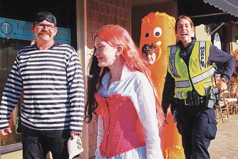 Samuel Jokich/Staff Correspondent The Hamburglar was just about to get away with his bag of loot – food? – before a laughing Murphy police officer finally caught up to the bandit Friday night in downtown Murphy, where there was costumes, candy and fun for all. Check out more images from Halloween events in both Murphy and Andrews on page 12A.