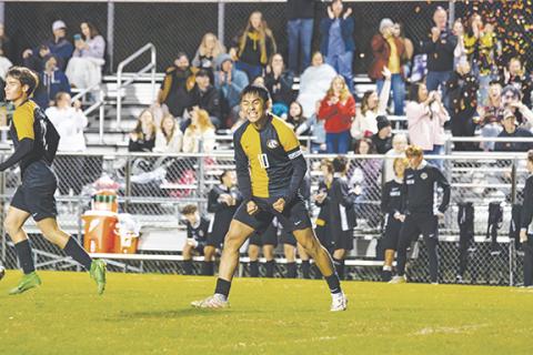 Cannon Crompton/sports@cherokeescout.com Jerry Bui of Murphy celebrates scoring a late goal against Queen’s Grant in the second round of the state 2A playoffs as fans shoot off confetti Thursday. 