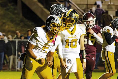 Cannon Crompton/sports@cherokeescout.com Murphy running back Cameron Clem (left, No. 5) yells after scoring a touchdown in the third quarter against Swain County on Friday.