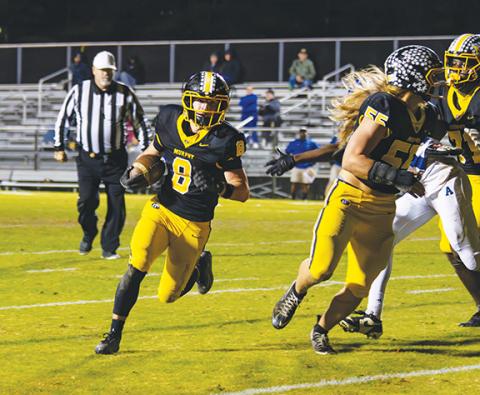 Cannon Crompton/sports@cherokeescout.com Blake Davis (No. 8) of Murphy breaks for the end zone while Brody Orton (No. 55) defends in the second-round state 2A playoff game against Albemarle on Friday. 