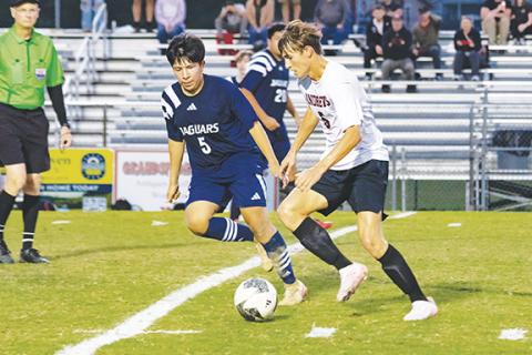 Cannon Crompton/sports@cherokeescout.com Gabe Clark (right) of Andrews runs with the ball while Elias Diaz-Menchu (left, No. 5) of Tri-County Early College defends in their match on Oct. 9.