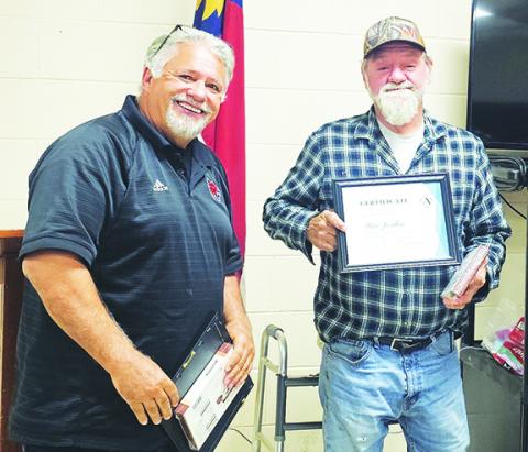 Andrews Mayor James Reid (left) presents Alderman Steve Jordan with a plaque of appreciation and box of candy for his 20-plus years of service at the November meeting of the Town of Andrews. Jordan lost his bid for re-election this year amid a series of appeals after his residency eligibility was contested. He appealed to the state but ultimately lost and was removed from the Nov. 4 ballot.