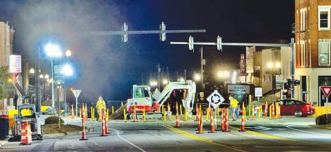 Crews work through the evening hours installing a roundabout in Downtown Murphy.