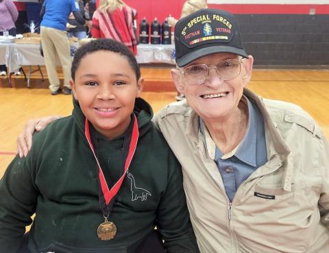 Fifth-grader Jackson Hughes (left) enjoys breakfast with his “special uncle,” Tommy Shaver, during Andrews Elementary School’s Veterans Breakfast on Nov. 10. Shaver, who honorably served in the 5th Special Forces as a Green Beret during the Vietnam War, said he likes to visit with Jackson every chance he gets and was thrilled to be at the breakfast.   Nicole Wright/Staff Correspondent
