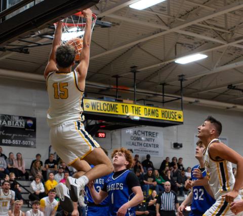 Cannon Crompton/sports@cherokeescout.com Abram Twiggs (No. 15) of Murphy dunks against Hiwassee Dam. 