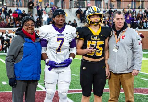 Cannon Crompton/sports@cherokeescout.com Before the game state 2A championship on Dec. 13, Murphy’s Brody Orton (second from right) and Tarboro’s Tyler Powell (second from left) were given the Sportsmanship Awards for 2A. They are joined by NCHSAA Commissioner Que Tucker (far left) and NCHSAA vice president Mark Garrett (far right).