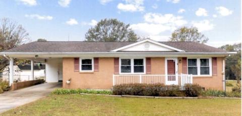 Brick ranchers sold for $15,000 in the 1970s … now more than $200,000 … single carport dates this yellow-brick model.
