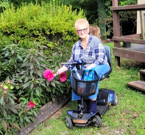 Joy Lynn Hale of Murphy has not let the accident keep her from doing things she enjoys, like gardening and operating Moorehouse Ministries’ food pantry.    Donald Hale/Contributing Photographer 