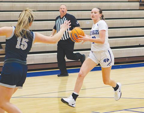 Cannon Crompton/sports@cherokeescout.com Abby Harris of Hiwassee Dam goes down the court driving toward the hoop while Delaney McLean (No. 15) of Nantahala defends on Dec. 8.