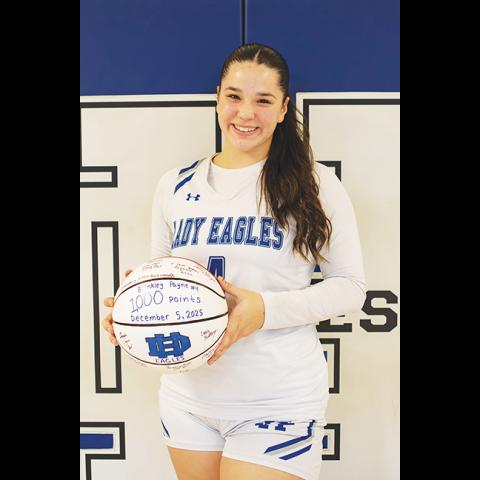 Cannon Crompton/sports@cherokeescout.com Brinkley Payne of Hiwassee Dam scored the 1,000th point in her high school basketball career on Dec. 5 against Swain County. At the Lady Eagles’ game on Dec. 8, she was honored and given a basketball signed by her teammates and coaches.