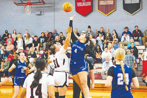 Cannon Crompton/sports@cherokeescout.com Alexis Beasley (left) of Andrews and Brinkley Payne (right) of Hiwassee Dam jump for the ball at the start of the game on Nov. 25.