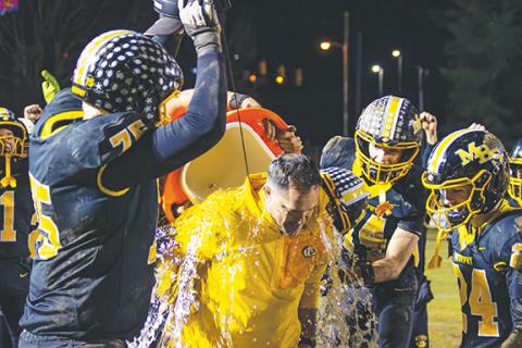 Cannon Crompton/sports@cherokeescout.com Murphy players empty a water cooler on head coach Joseph Watson after winning the 2A Western Regional championship Friday night. 