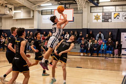 Cannon Crompton/sports@cherokeescout.com Cole McCoy of Nantahala takes a shot over a Highlands defender during their game last season on Feb. 13.