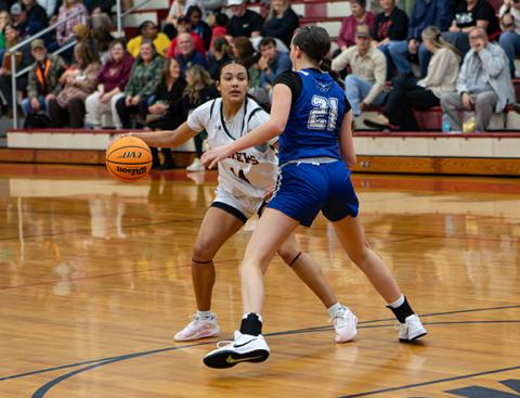 Marley Blackwell (left, No. 14) of Andrews dribbles at the top of the arch as Abby Harris (right, No. 21) of Hiwassee Dam defends on Nov. 25.