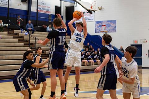 Jonah Dockery (No. 20) of Hiwassee Dam takes a jump shot while Nantahala looks to defender in the game on Dec. 8.