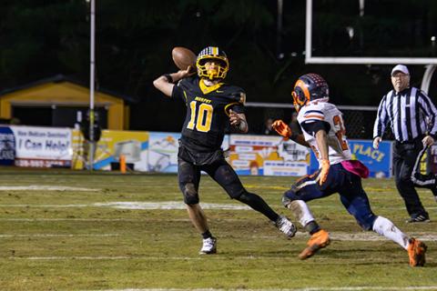 Murphy quarterback Brady Grant looks for an open receiver downfield while fending off a Starmount defender during the 2A Western Regional championship on Dec. 5.