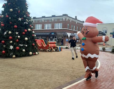 Murphy Police Sgt. Adam May and Chief Tim Lominac of the Murphy Police Department chased the Gingerbread Man (Hayden Williamson) around downtown.
