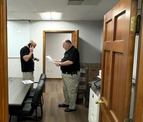 Cherokee County Emergency Management officials Sam Davis, left, and Bobby Barton meet Friday morning to go over the 10 a.m. briefing shortly before posting it. 