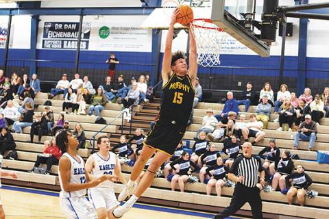 Cannon Crompton/sports@cherokeescout.com Abram Twiggs of Murphy flies through the air to dunk the ball against Hiwassee Dam on Jan. 13.