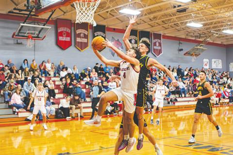 Cannon Crompton/sports@cherokeescout.com Brady McLelland of Andrews goes up for a shot while Abram Twiggs of Murphy looks to block it Friday night.