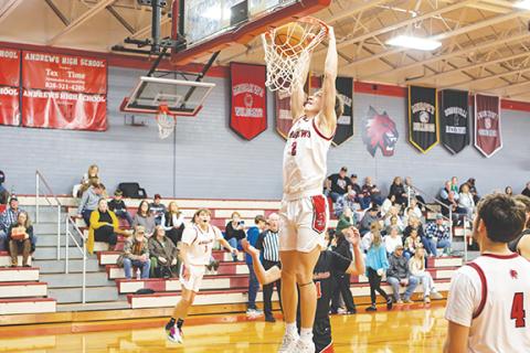 Cannon Crompton/sports@cherokeescout.com Logan Shuler of Andrews dunks the ball against Rosman on Thursday. 