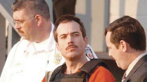 Hal Yeager/Birmingham News Eric Rudolph is escorted by Murphy Police Chief Mark Thigpen (left) and Cherokee County Sheriff Keith Lovin (right) from the Cherokee County Jail on June 2, 2003.