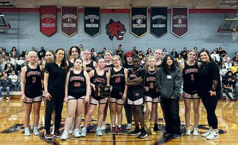Racquel Mabry/Contributing Photographer The Andrews Middle School basketball team after falling in the conference championship Saturday. Front row (from left): coach Sarah Dunn, Alexis Flowers, Kimberlynn LeQuire, Kylie Blackwell, Nariah Roehm, Eavey Ashe, Sumire Evans, Hadley Adams and assistant coach Haley West. Back row (from left): Aubrey Hedden, Tori Cook, Audrey McLelland, Sissy Ashe, Jaley West, Jammebelle Hill and Reagan Adams.