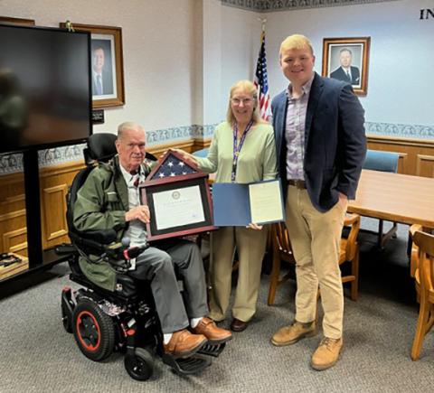 Cynthia J. Butts (center) receives recognition for her decades of faithful caregiving for her veteran husband, Chief Warrant Officer Steve L. Butts (left), U.S. Army (Retired), and other veterans. Lake Silver (right), field representative from U.S. Rep. Chuck Edward’s office, visited Murphy City Hall on Dec. 18, 2025, to present her a Certificate of Recognition honoring her longstanding commitment to caring for veterans and their families.