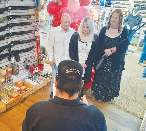 Anngee Quinones-Belian/Staff Correspondent Ernie Sherman and Melissa Wright tied the knot at Cherokee Guns in Murphy on Saturday for Valentine’s Day. Bridesmaid Beth Picklesimer held a free shotgun wedding gift. 