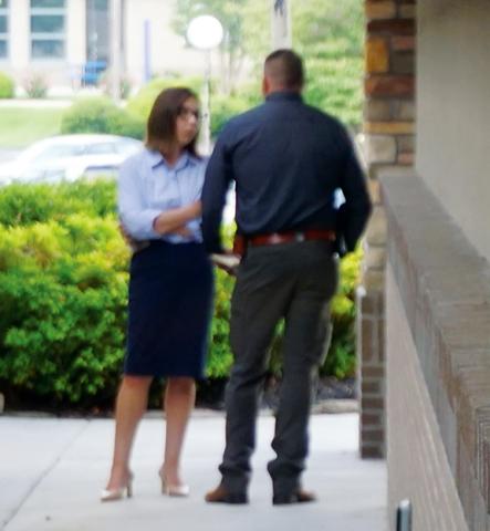 Randy Foster/editor@cherokeescout.com Then-Cherokee County Sheriff Dustin Smith and District Attorney Ashley Welch confer privately ahead of a press conference on the day Detention Officer Francisco Flattes was killed during an escape attempt. Welch listed that homicide among several other incidents as cause for Smith to resign.