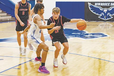 Cannon Crompton/sports@cherokeescout.com Levi Clark (right) of Andrews drives past Xavier Johnson of Hiwassee Dam on Friday.