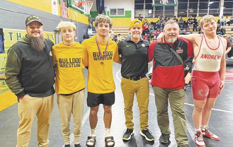 Cheryl Catuto/Contributing Photographer Three athletes from Cherokee County earned a spot in the state tournament with strong performances at the West Regional tournament. From left are Murphy wrestling coach Justin Daugherty, Weston Adams, Anthony Catuto, Murphy wrestling coach Mike Catuto, Andrews wrestling coach Rex Cable and Hayden Virtanen.