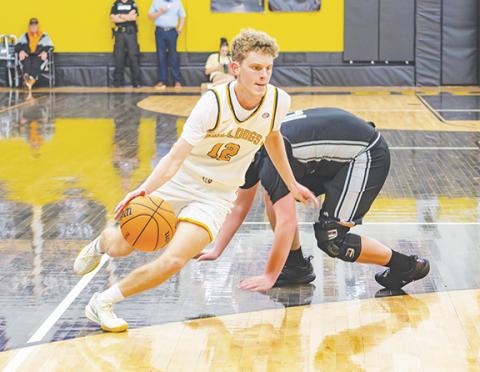 Cannon Crompton/sports@cherokeescout.com Murphy senior Tyler Payne drives toward the basket against Robbinsville on Friday.