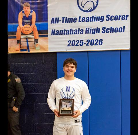 Cannon Crompton/sports@cherokeescout.com Nantahala senior Cole McCoy was honored with a plaque and banner Thursday for becoming the Hawks’ all-time leading scorer. He surpassed the previous record of 1,565 career points to etch his name in the school’s basketball history book.