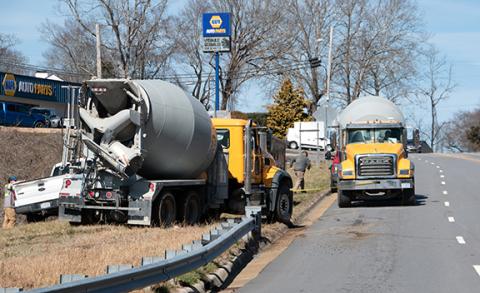 Randy Foster/editor@cherokeescout.com A cement truck pulls another cement truck after it got stuck on soft ground near the intersection of Peachtree Street and U.S. 19/74 in Murphy on Friday.