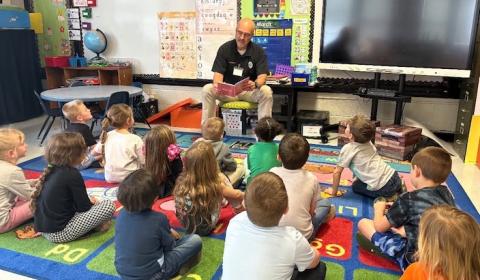 Murphy Police Chief Tim Lominac shares a Dr. Seuss story with local students on March 2