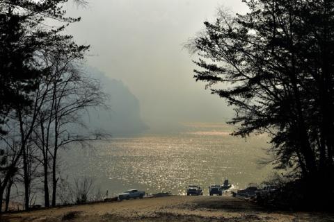 Randy Foster/editor@cherokeescout.com A boat ramp on Lake Hiwassee in the Ramsey Bluff area Friday shows smoke from a controlled burn nearby.
