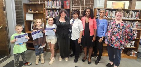 Awards for the Purel Miller African-American Reading Challenge were handed out at the Andrews Public Library. The sixth annual awards were given to 23 students across the three counties. From left, reading challenge winners Jackson Matthews; Tavish Singer and Waverly Hood; ODWC Executive Director Sarah Hardman; ODWC founder Ann Miller Woodford; Kristen George; chair of the Purel Miller African-American Reading Collection Janel Agyeman; and youth services librarian Bridget Wilson. 